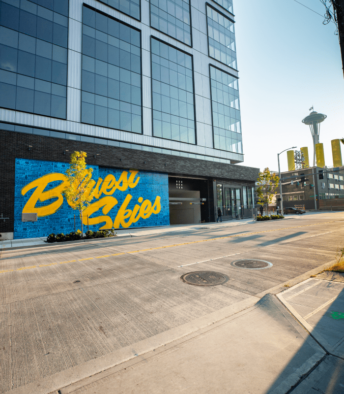 Electric Coffin - Bluest Skies Mural Street View with Space Needle in the Background
